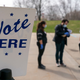 Poll worker Josh Harrison, center, works with Chad Donahue, right, during curbside voting on April 7, 2020, in Madison, Wisconsin.